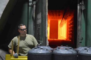 man-with-safety-glasses-standing-in-front-of-industrial-oven