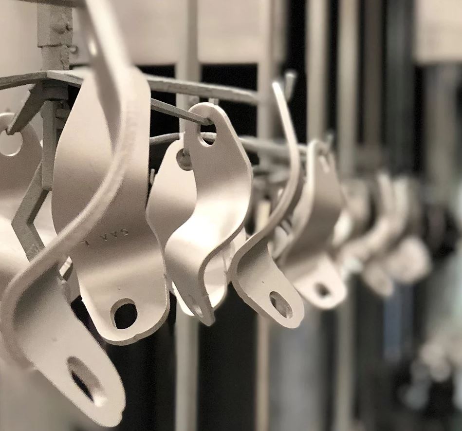 conveyor metal parts on a conveyor oven line